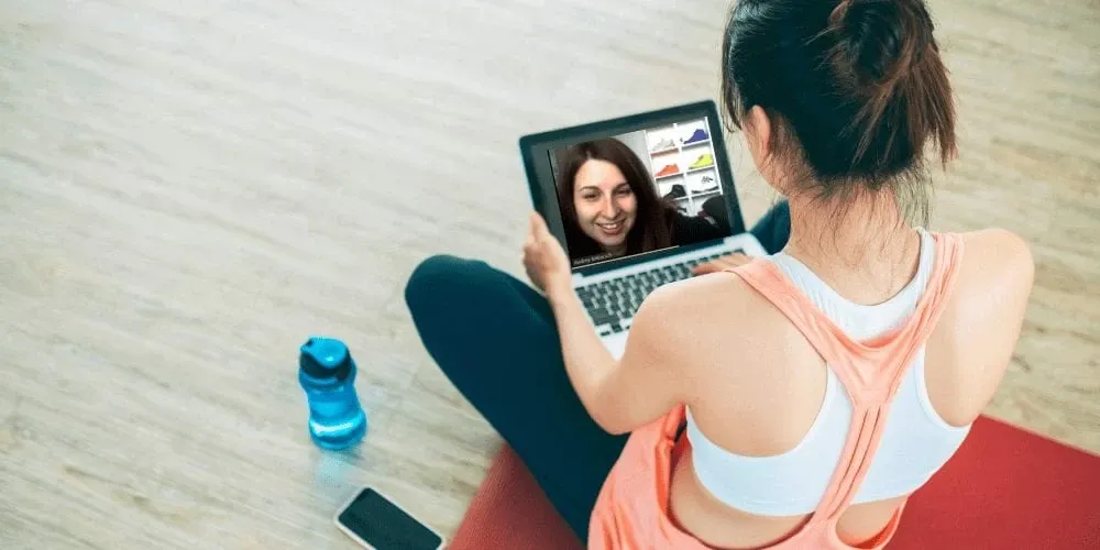 virtual personal trainer working with client in their home virtually