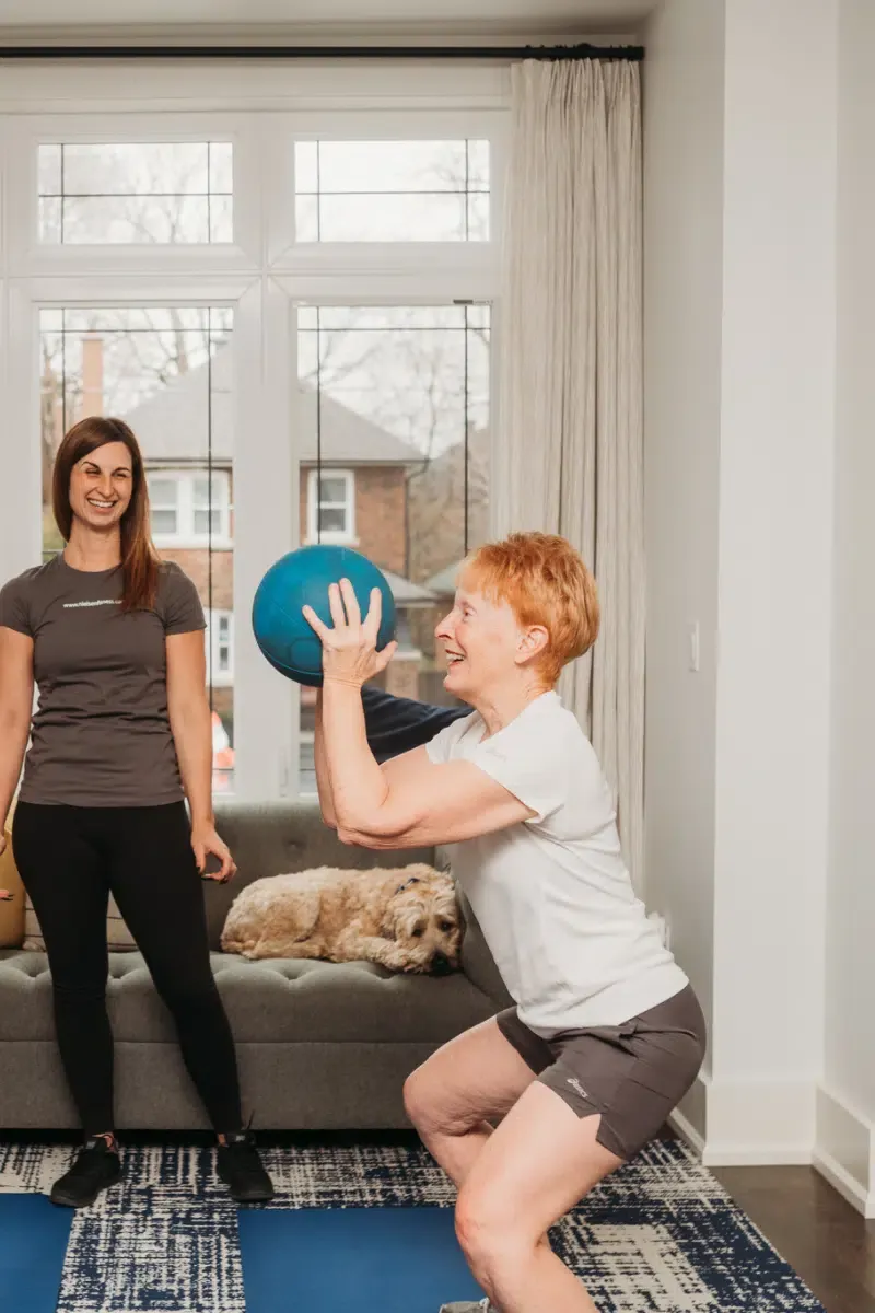 woman squats with medicine ball